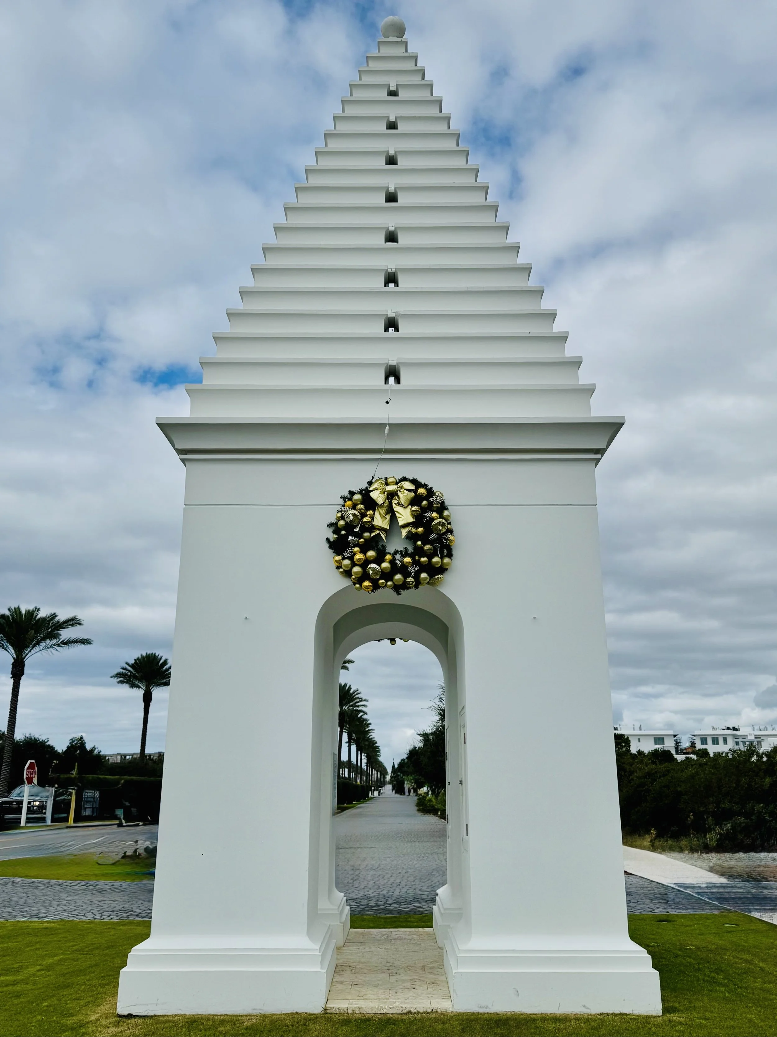 Signature white pyramid-shaped tower at the entrance of Alys Beach with a wreath decorated for winter holidays and Christmas