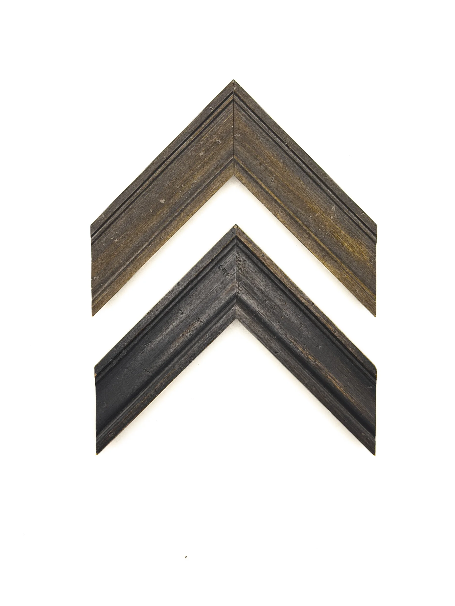 Traditional picture frame moulding in warm brown and deep charcoal-black finishes, featuring a gently stepped profile, subtle wood grain, and lightly distressed details. Available for custom framing in Wichita, KS at Dock 410, this versatile moulding