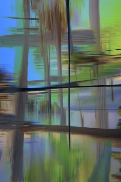 Abstract blurred window view with green and blue hues