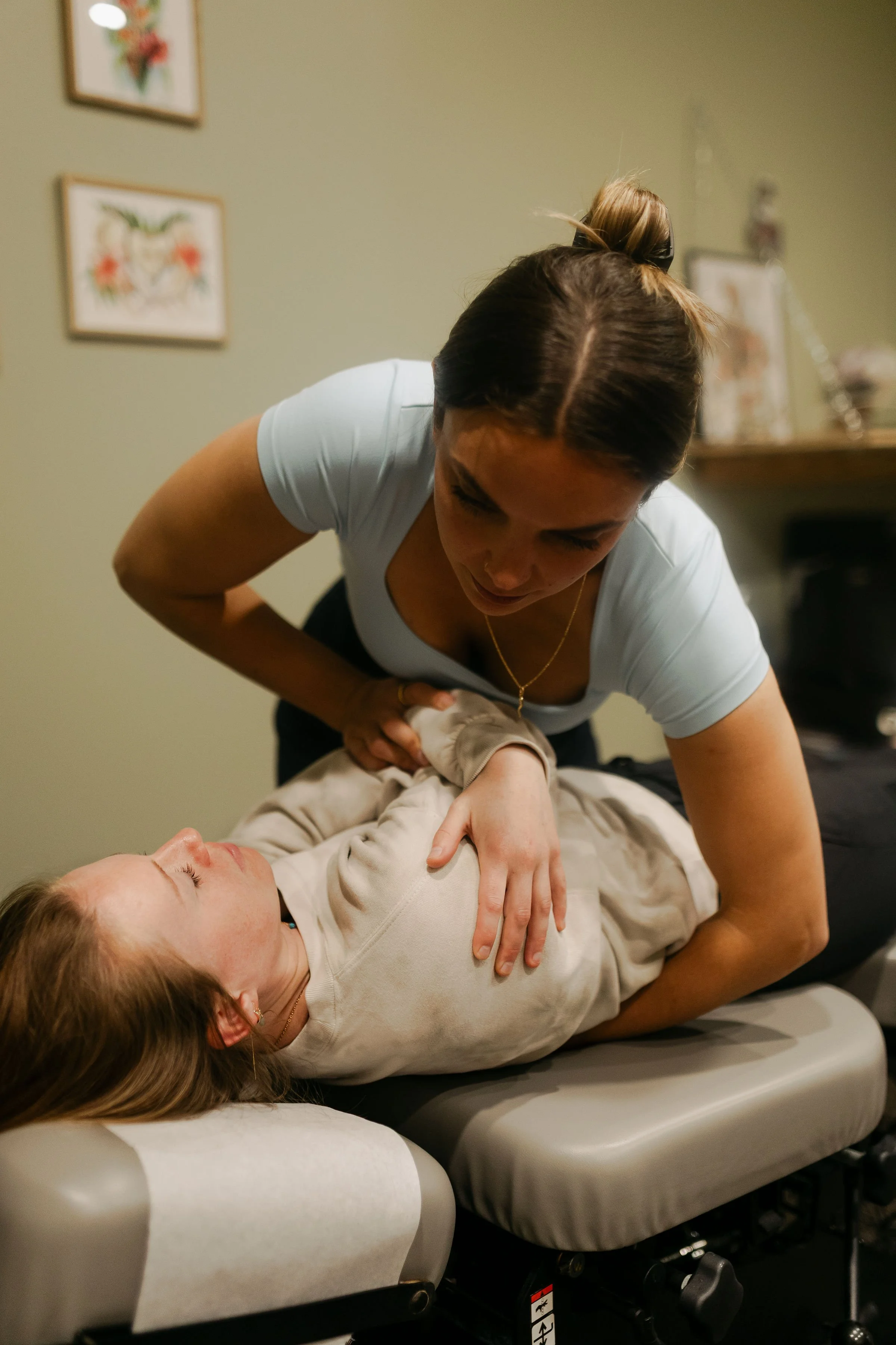 gentle woman female chiropractor hands adjustment
