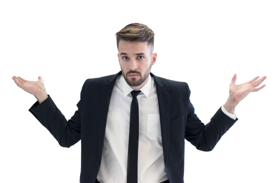 A young man in a black suit, white shirt, and black tie with a puzzled expression, shrugging with palms facing upward.