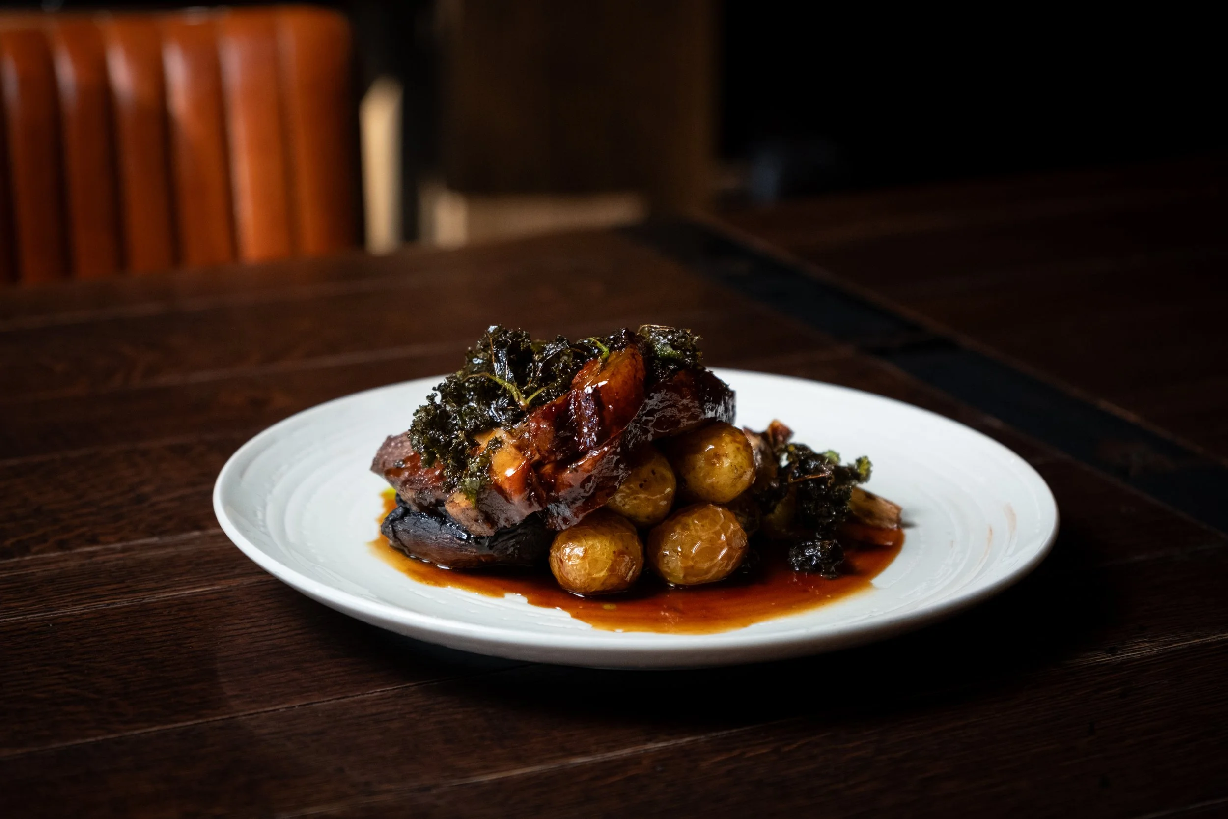 Stekt kjøtt med grønnsaker og poteter på en hvit tallerken