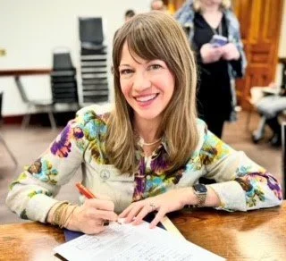 Rep. Anulewicz poses with her paperwork as she qualifies to run for reelection.