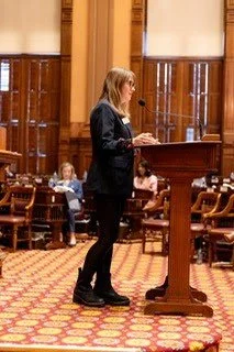 A side-profile photo of Rep. Anulewicz speaking at the well.