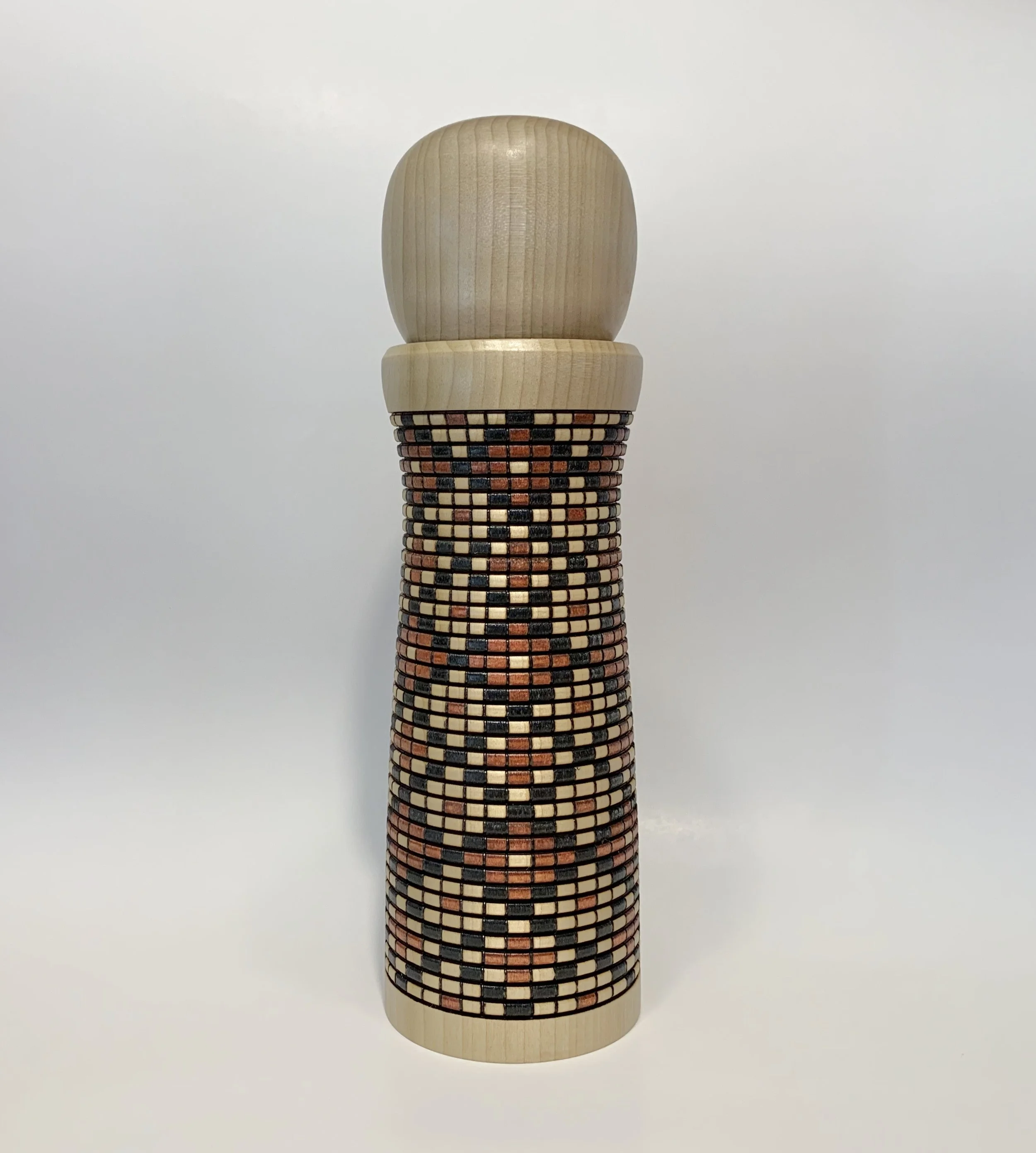 Handcrafted earthtone diamond pattern wooden pepper mill designed as functional art