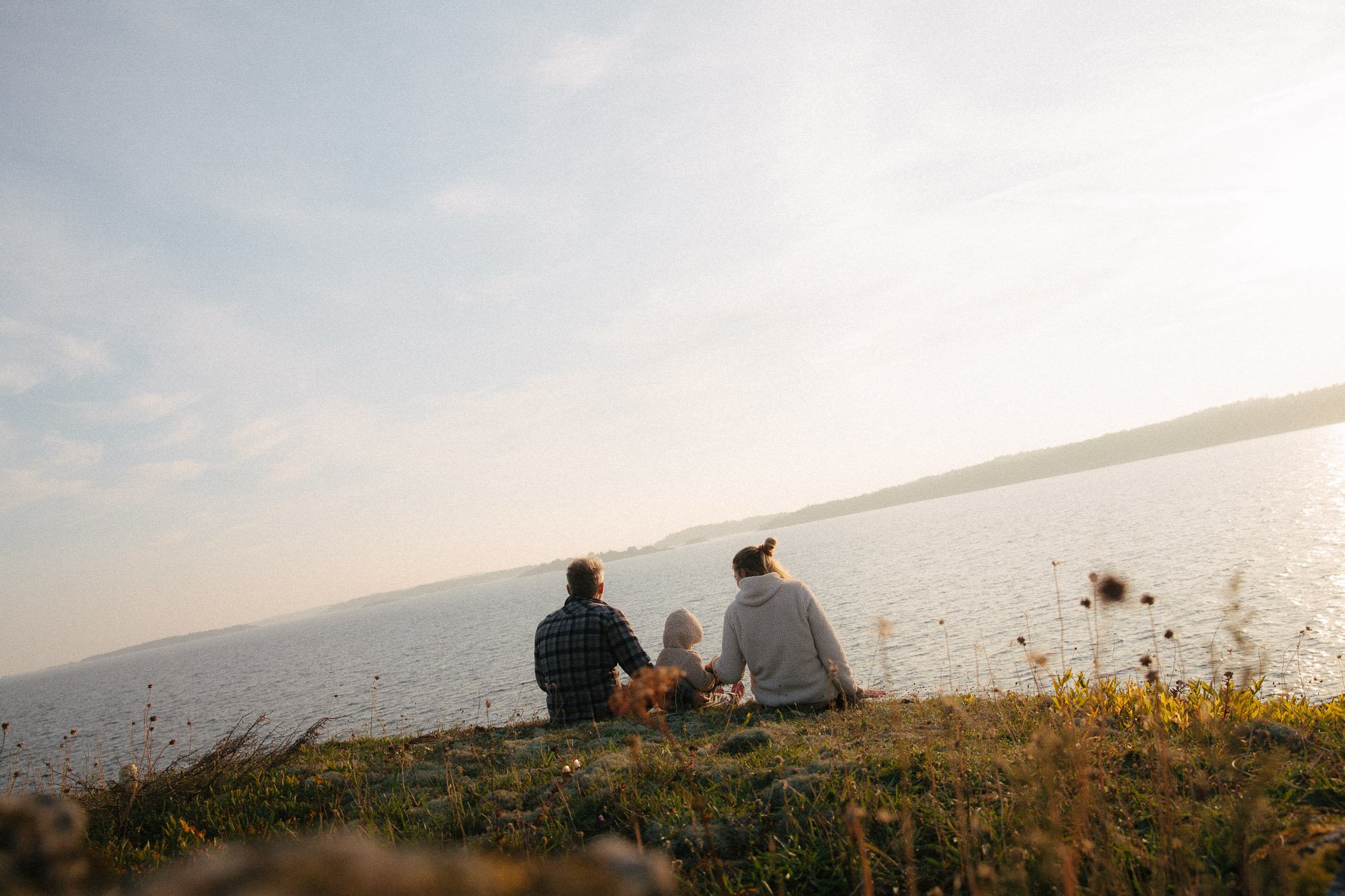 family of three on an island looking over the Baltic Sea