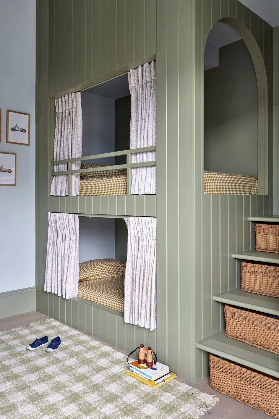 Boys’ bedroom with bespoke green bunk beds, curtains, blue walls and colourful joinery.