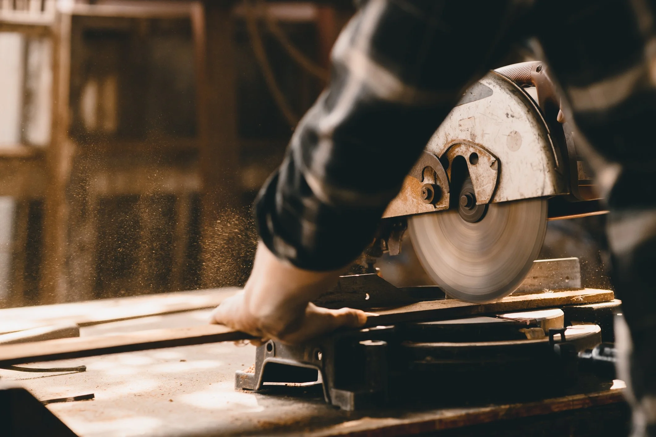Craftsman using a table saw for framing and finishing carpentry, showcasing NGage Properties Group’s meticulous approach to delivering dream homes, tailored for each family in their unique style.