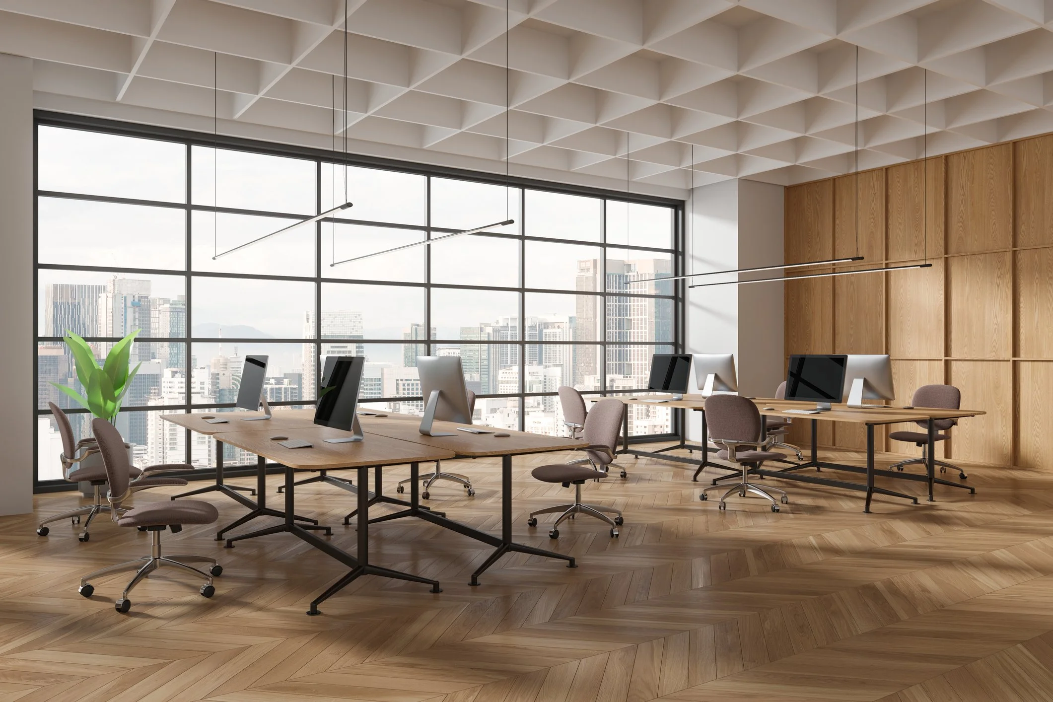 Modern office space with multiple desks and computers, large floor-to-ceiling windows with a city view, wooden flooring, and minimalistic decor.