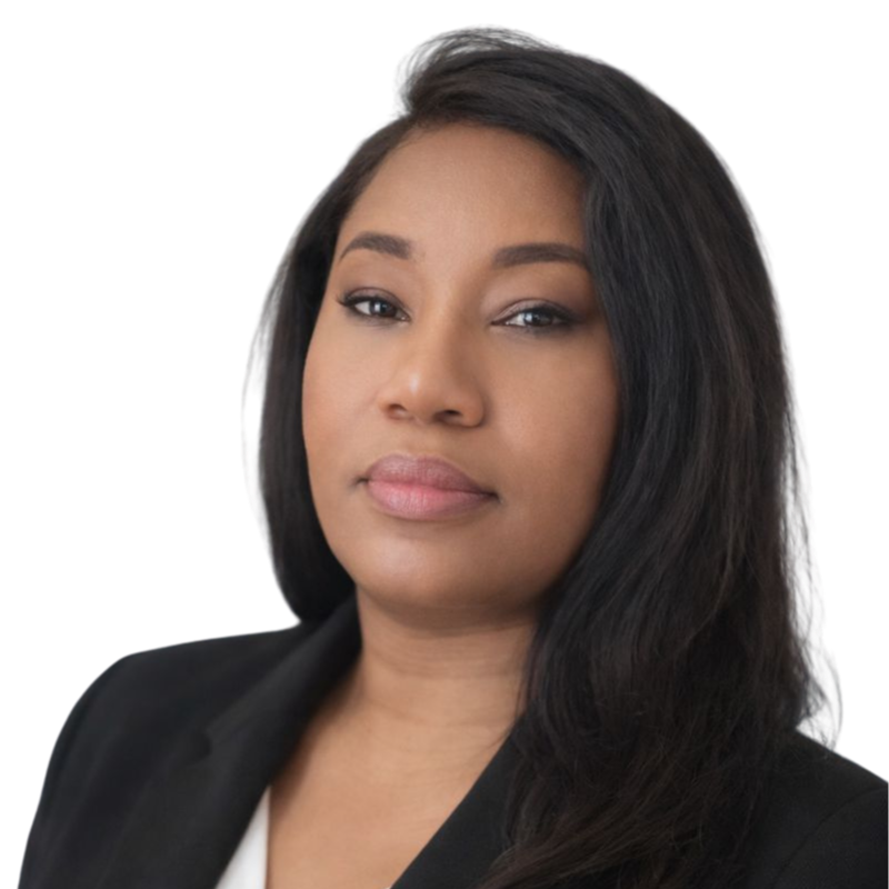 A woman wearing a pink medical scrub top with short sleeves and a v-neck, large black-rimmed glasses, and a colorful headband, standing against a plain white background.