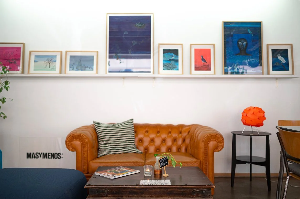 Coin salon du café-restaurant FOOUND à Genève, canapé Chesterfield et œuvres d'artistes