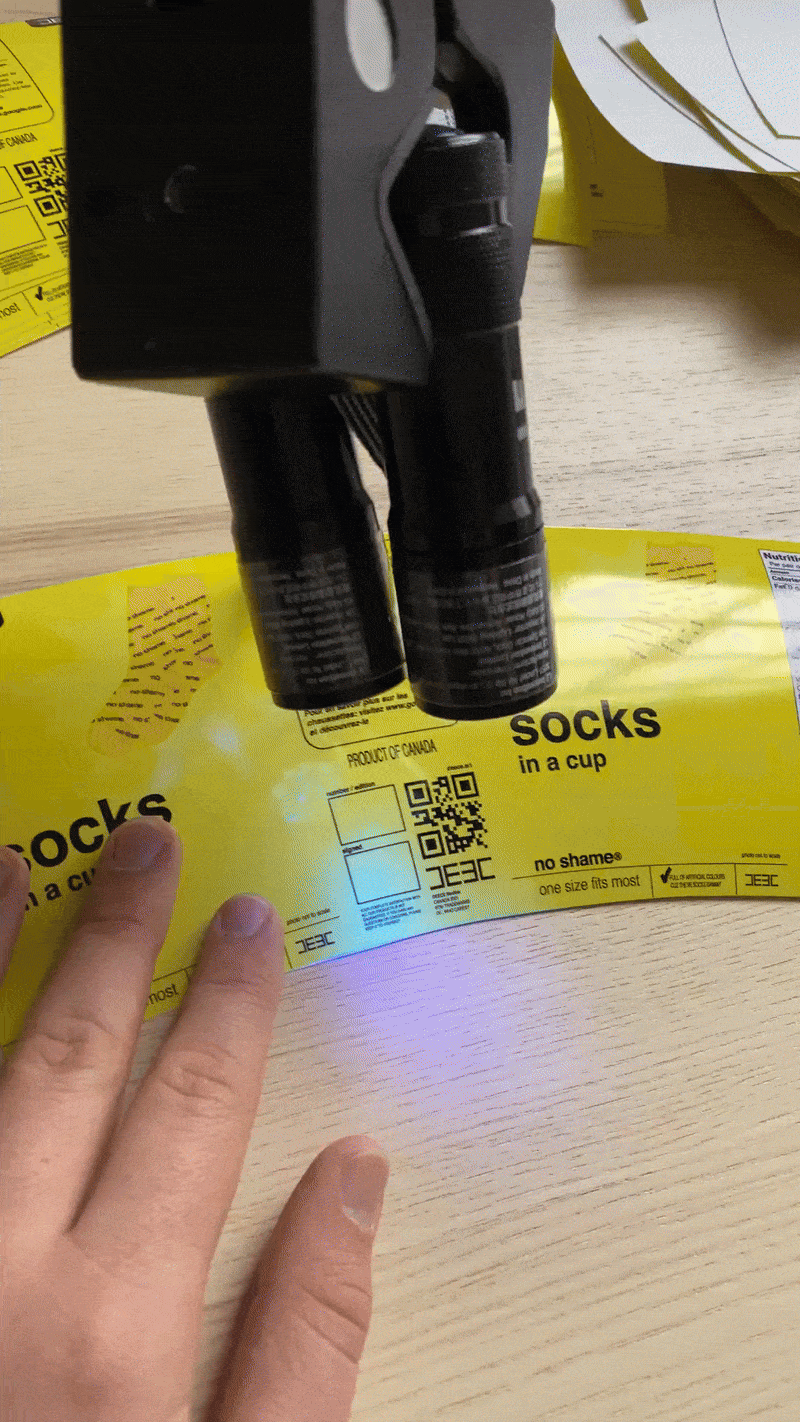 Signing limited edition No Shame socks in a cup. (Copy) (Copy)