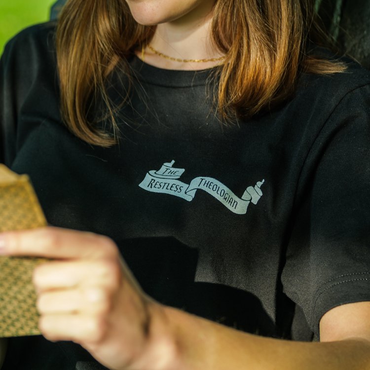 Woman wearing The Restless Theologian logo T-Shirt, front view.