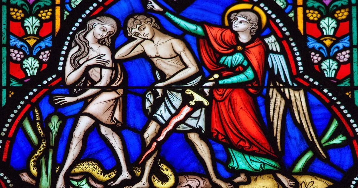 Stained glass depiction of the Fall of Man showing Adam and Eve with the serpent and an angel, illustrating the biblical account of original sin in Genesis.