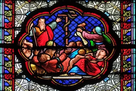 Moses lifting the bronze serpent—symbol of healing and a biblical warning about images becoming objects of devotion in worship.