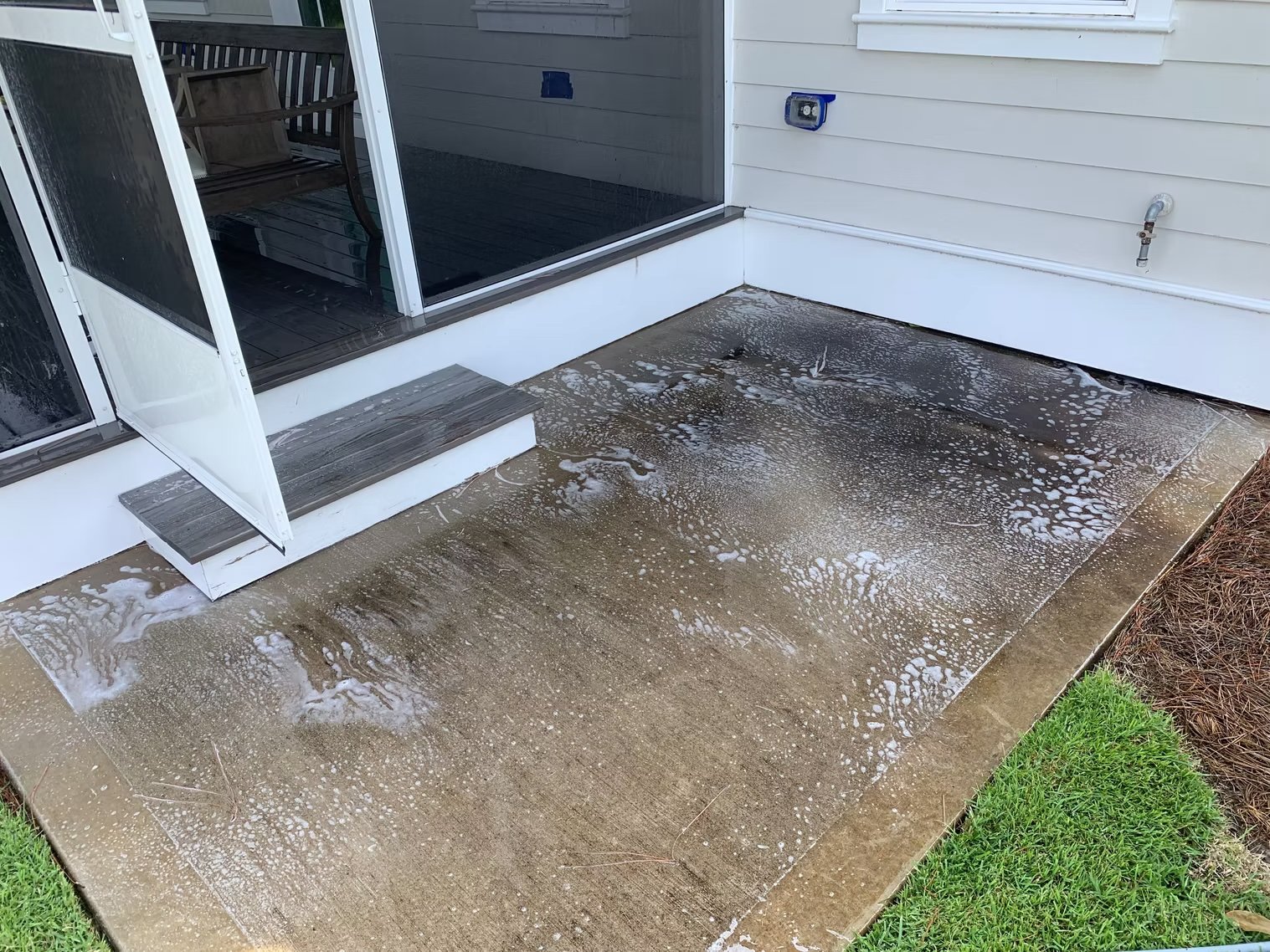 A concrete patio before being professionally cleaned