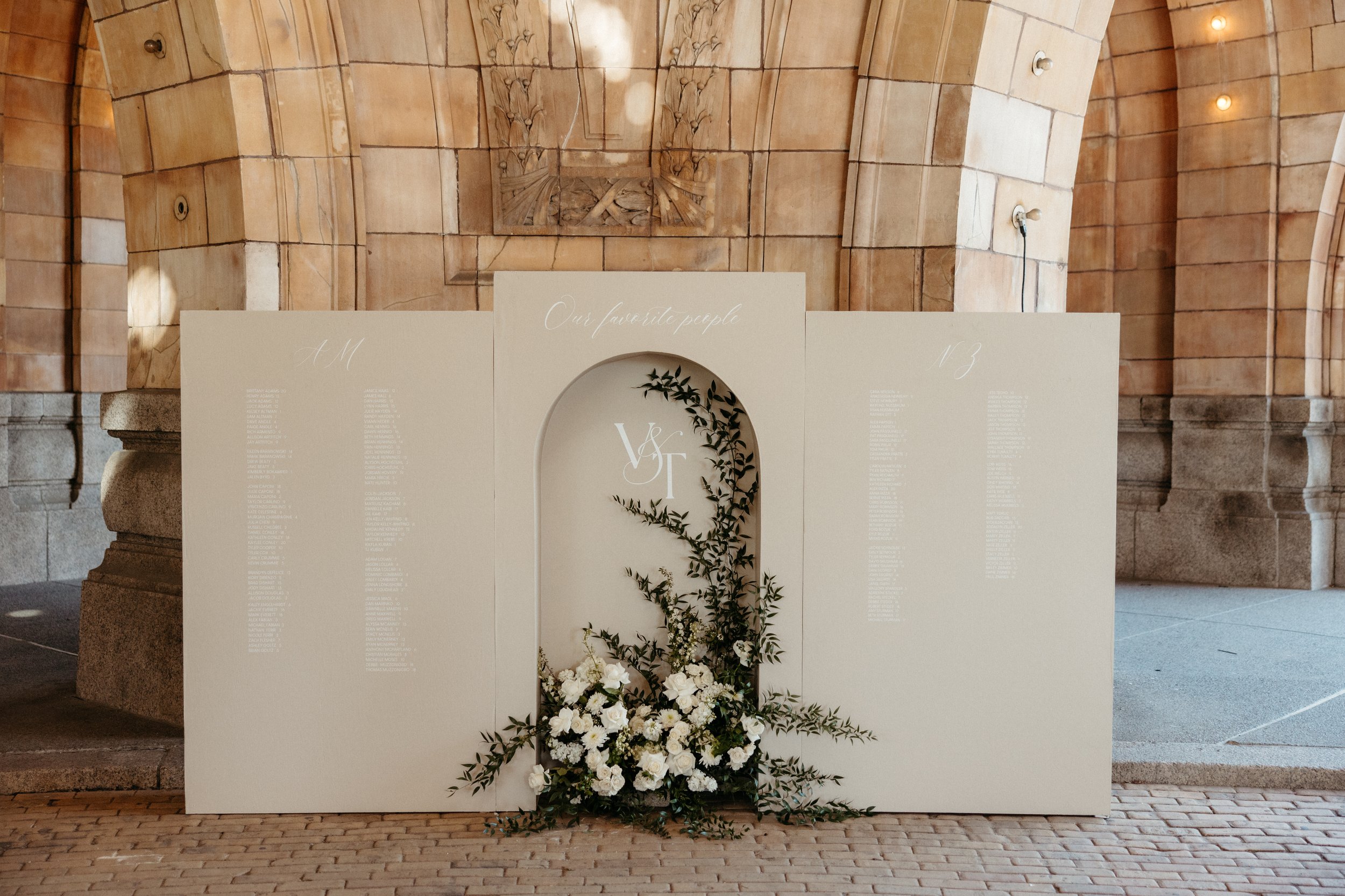 Wedding seating chart with champagne glasses on shelves, elegant decor