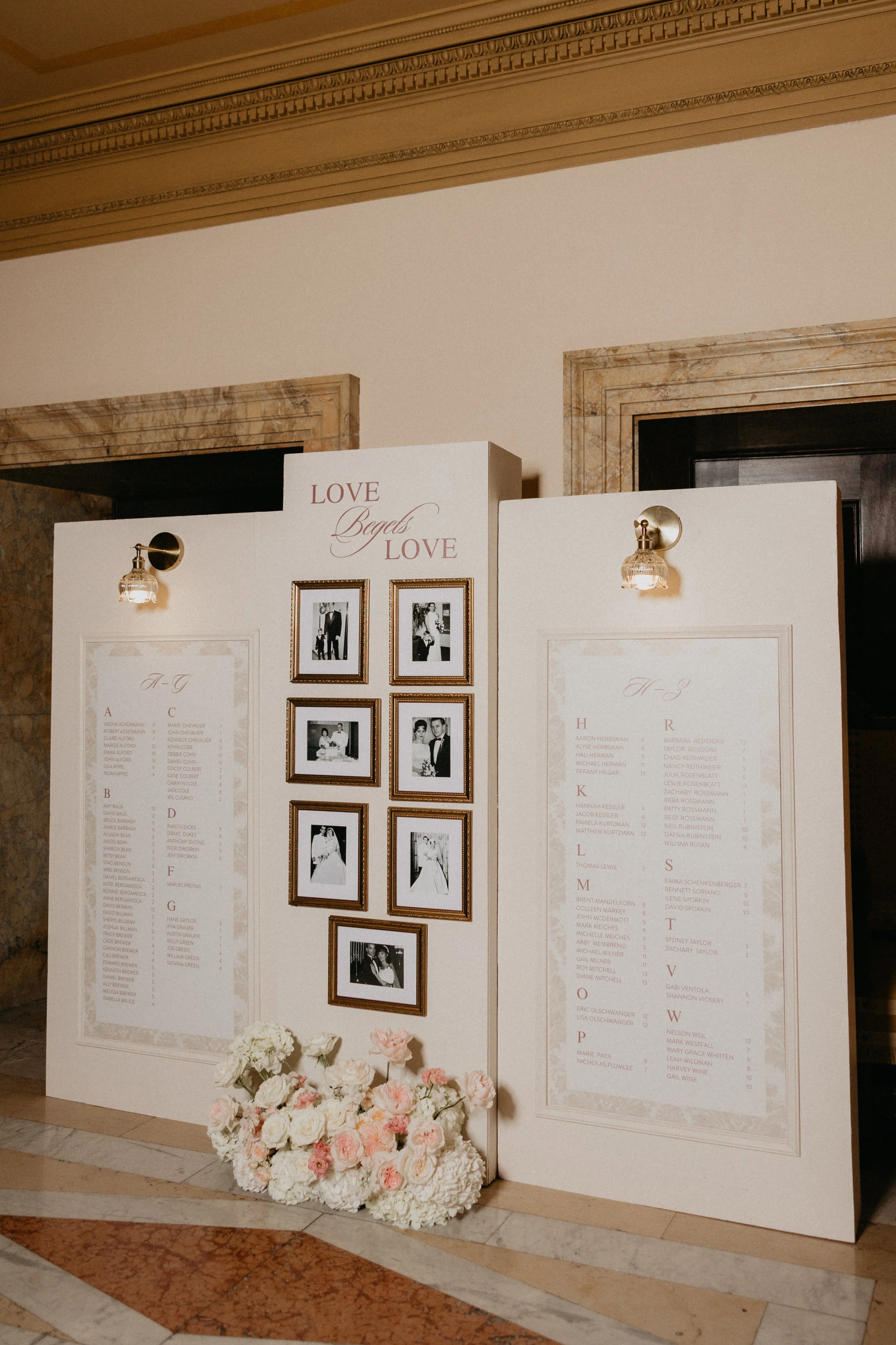 Wedding escort card display with floral arrangements and "I pick you" sign
