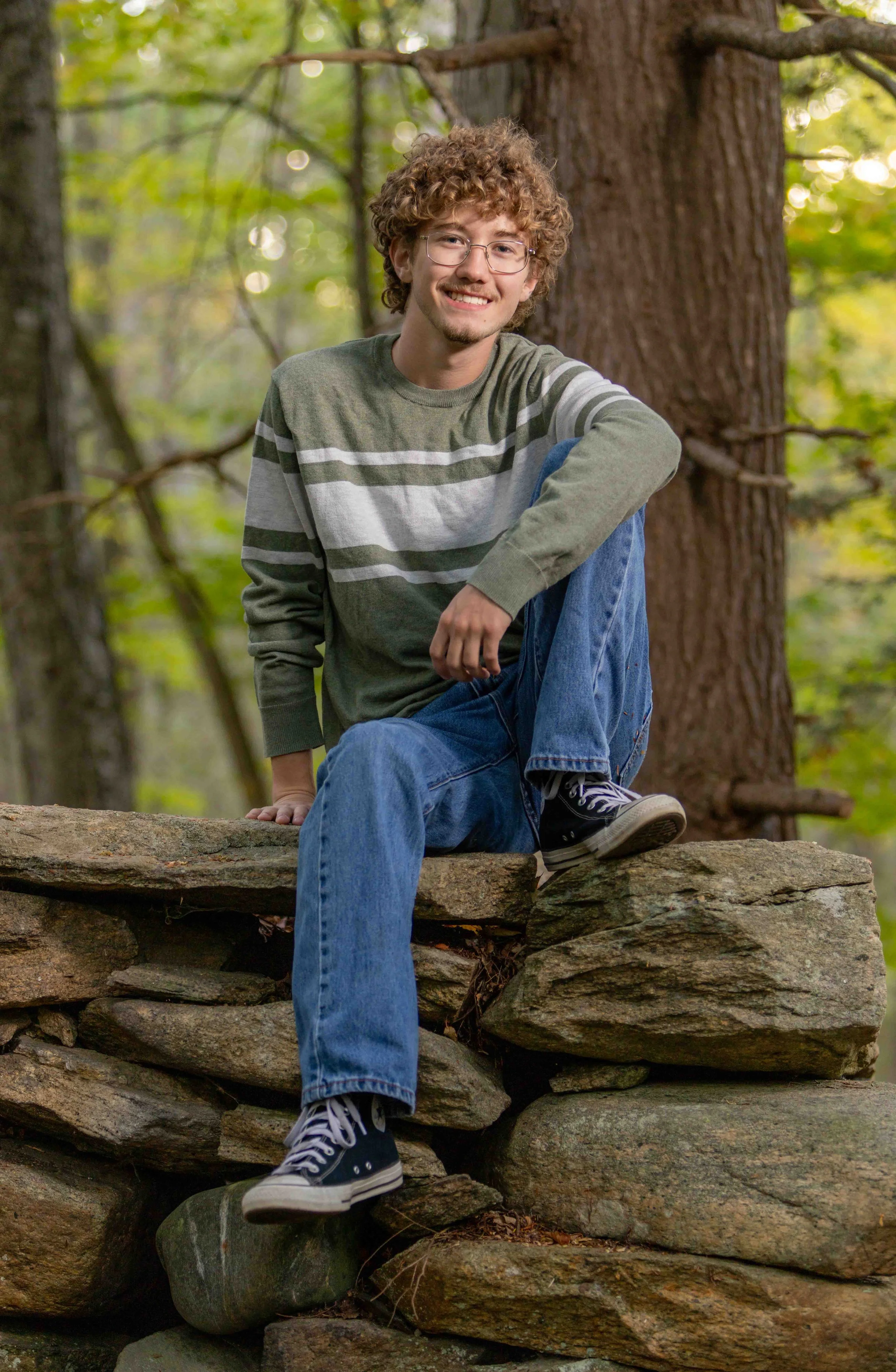 sittingonrockwallsmile.jpeg