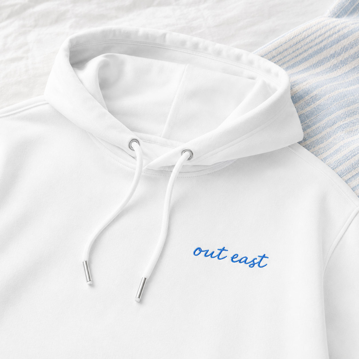 OUT EAST WHITE HOODIE CLose up.png