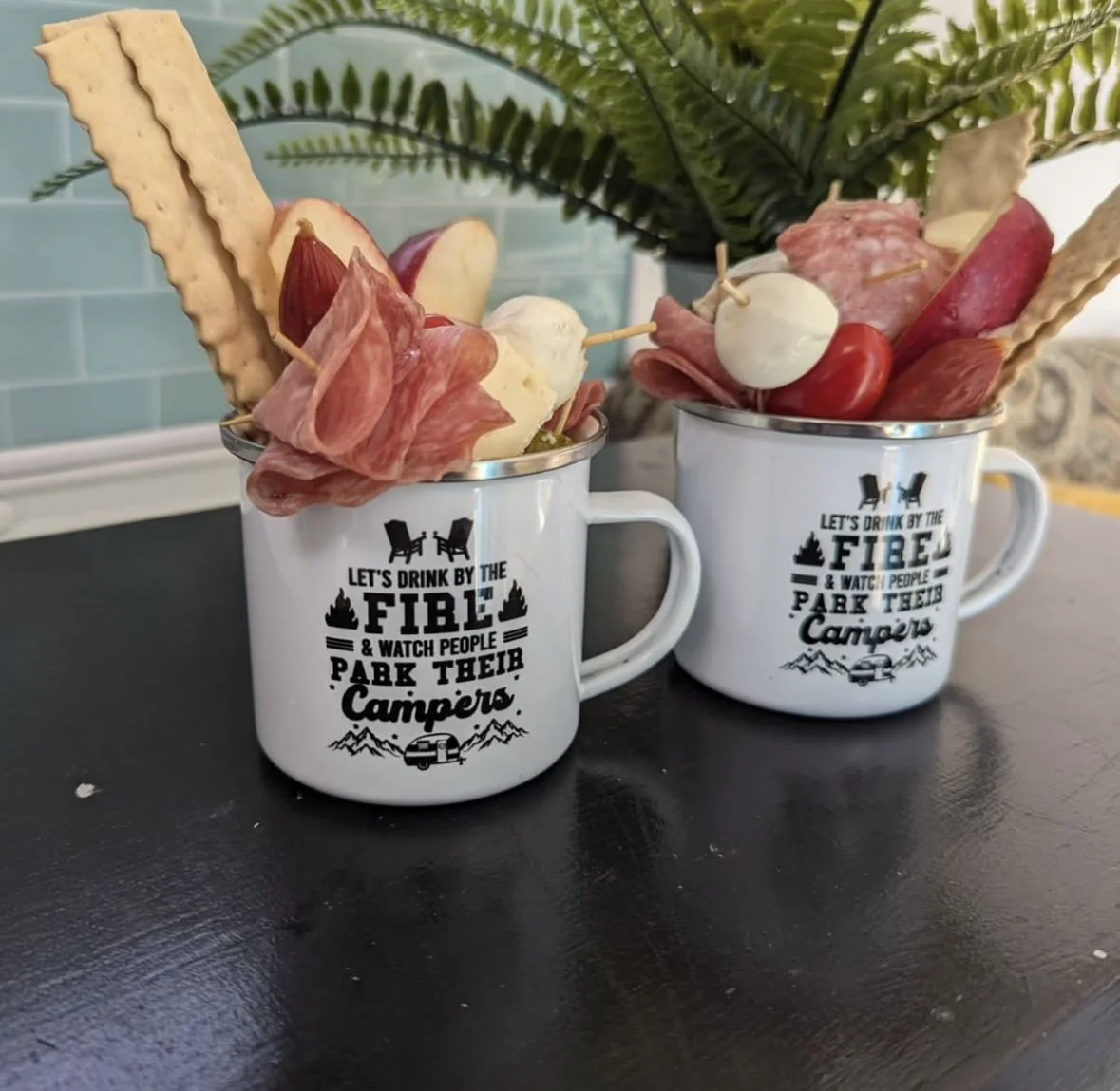 A charcuterie board with assorted cheeses, crackers, nuts, red grapes, sliced meats, and a bowl of red jam.