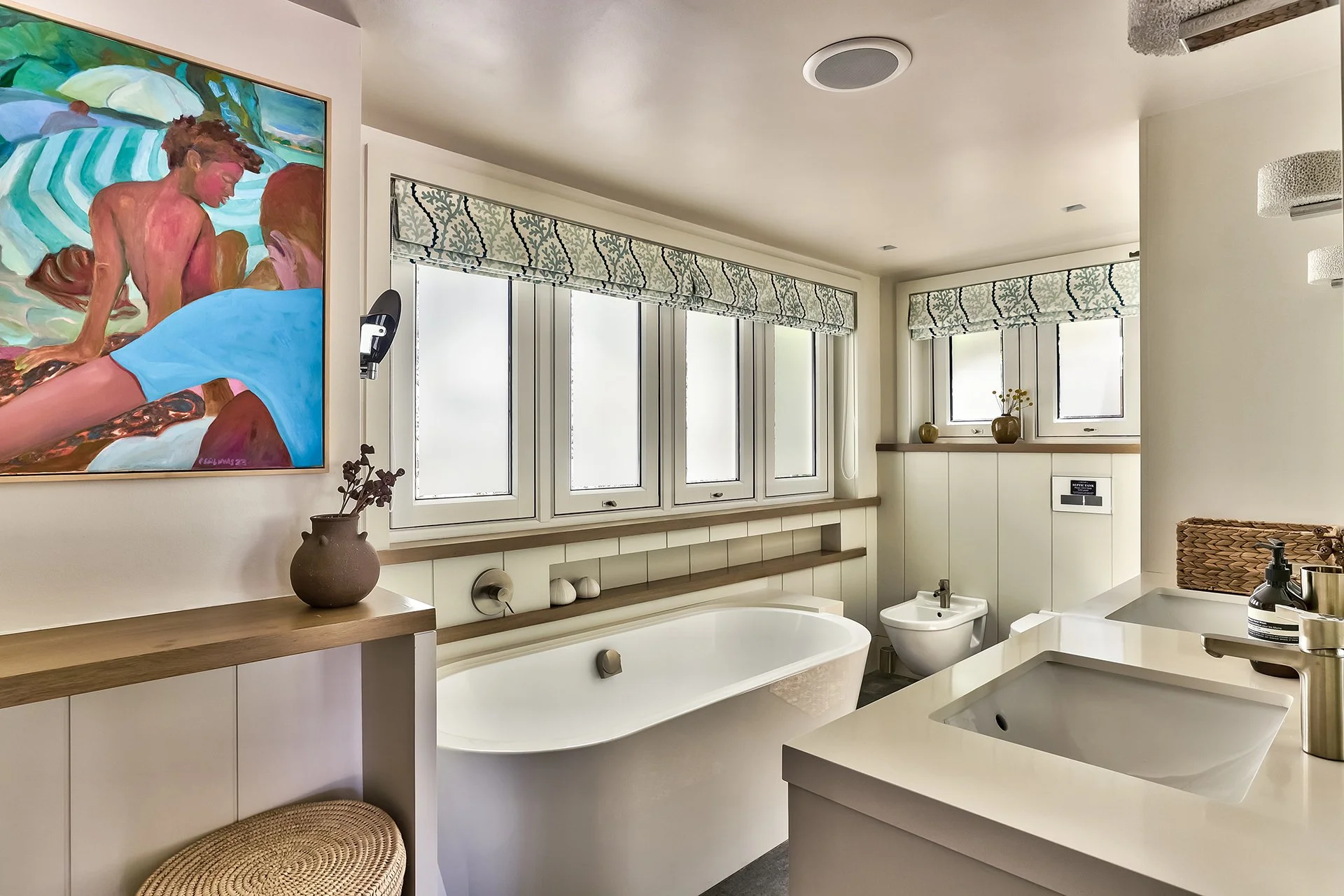 The master bedroom has a spacious bathroom with two sinks, shower and contemporary freestanding oval bath.