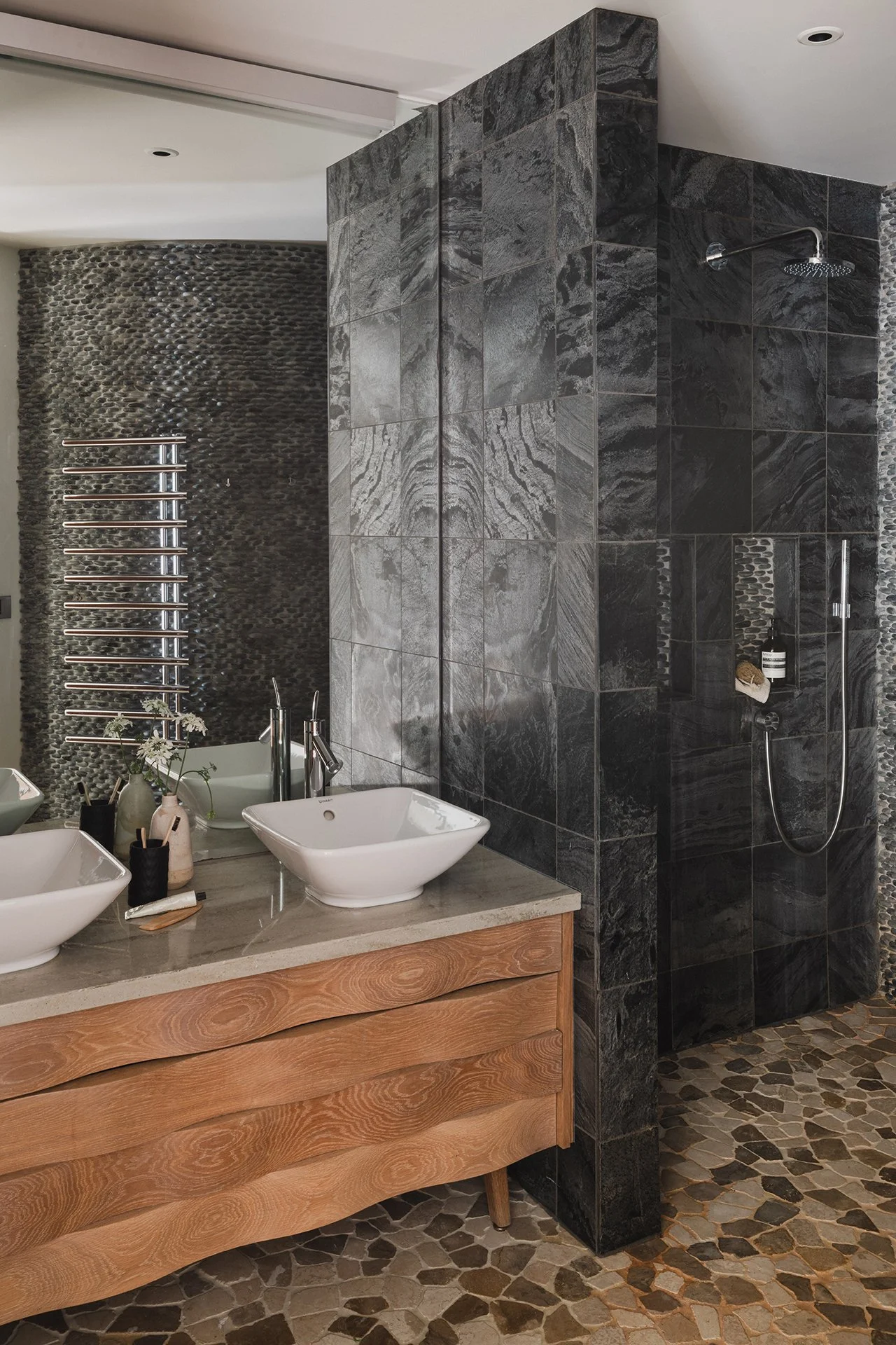 En suites have Hansgrohe deluge showers and Fired Earth and Island Stone tiles; three bedrooms have a freestanding Castello bath.