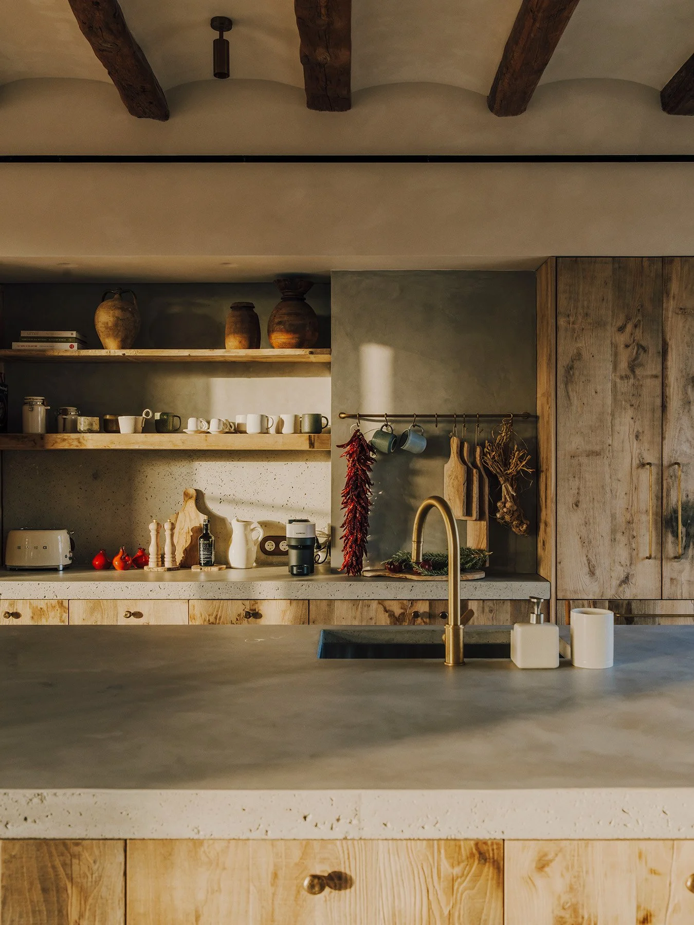 A spacious open-plan kitchen, equipped with state-of-the-art Gaggenau appliances including induction hob, double oven, microwave, coffee machine, double dishwasher and fridge freezer.