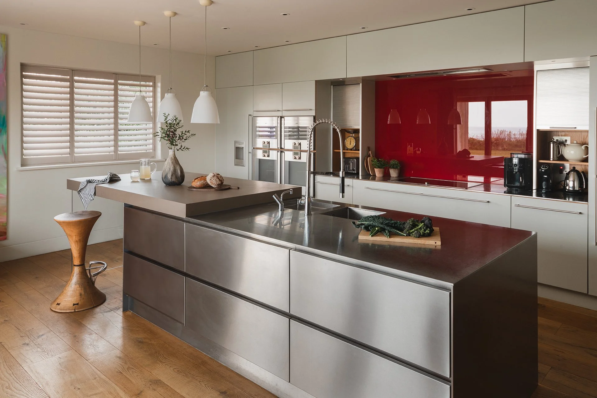 The kitchen has a stylish breakfast bar and utilises luxury appliances by Gaggenau and surfaces made from local stone.