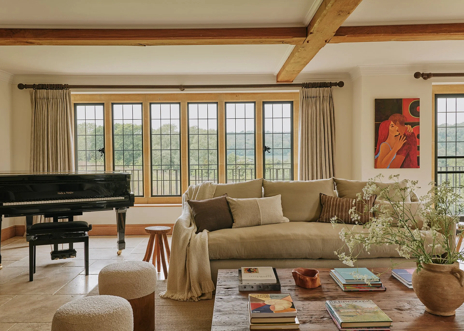 The living room is stylish and elegant, with a large woodburning stove, flagstone flooring, decadent rugs and two sumptuous sofas... There’s also a baby grand piano - arrangements can be made for a local pianist to play for you.