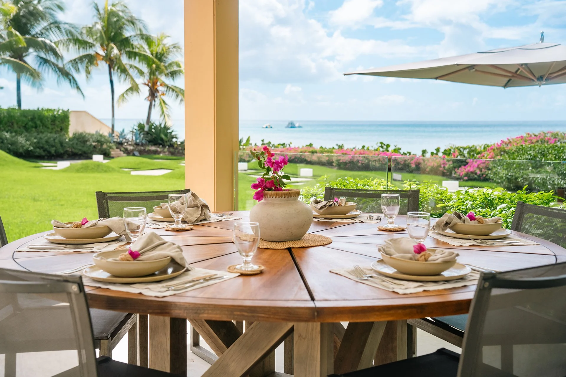 Two shaded dining areas and a yoga pavilion at SimonEscapes Godings Beach House in Barbados.