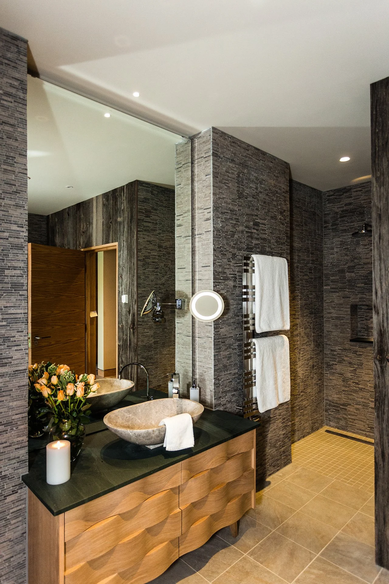 Two bedrooms have oval baths overlooking Lake Windermere. All bathrooms have Mandarin Stone walls and giant Drench showers.