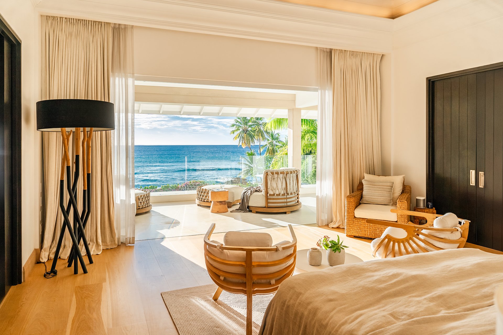 A double staircase with feature Verpan seashell chandelier leads upstairs to five spacious en suite bedrooms, some with four-poster beds; all with American oak flooring, Ralph Lauren bed stools and other unique design pieces.