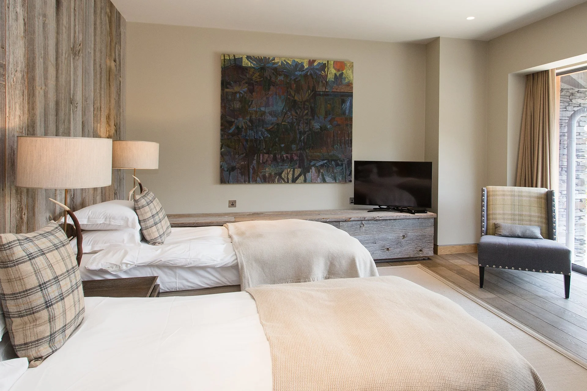 A glass and stainless-steel staircase leads up to the bedrooms all with floor-to-ceiling windows – two have oval baths overlooking the lake, for the ultimate relaxing soak.