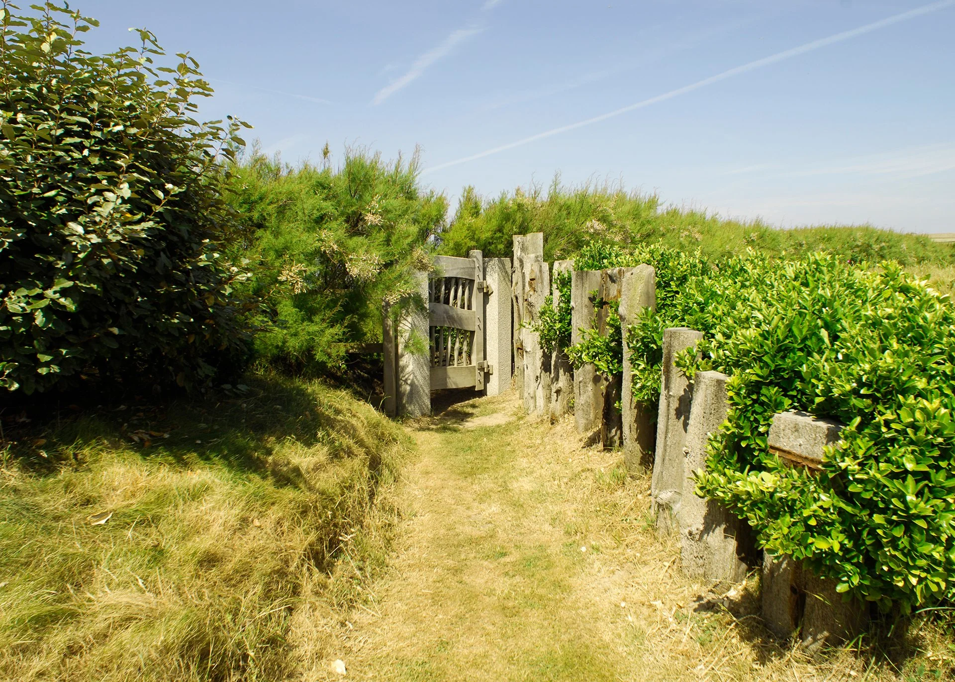 Outside, an acre of garden includes a terrace with sun loungers and a BBQ area. A gate gives direct access to the South West Coastal Path and the beach.