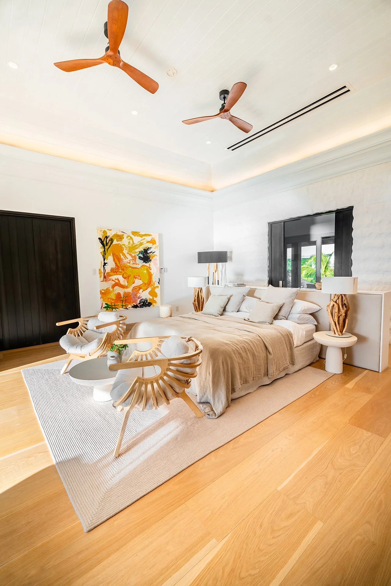 A double staircase with feature Verpan seashell chandelier leads upstairs to five spacious en suite bedrooms, some with four-poster beds; all with American oak flooring, Ralph Lauren bed stools and other unique design pieces.