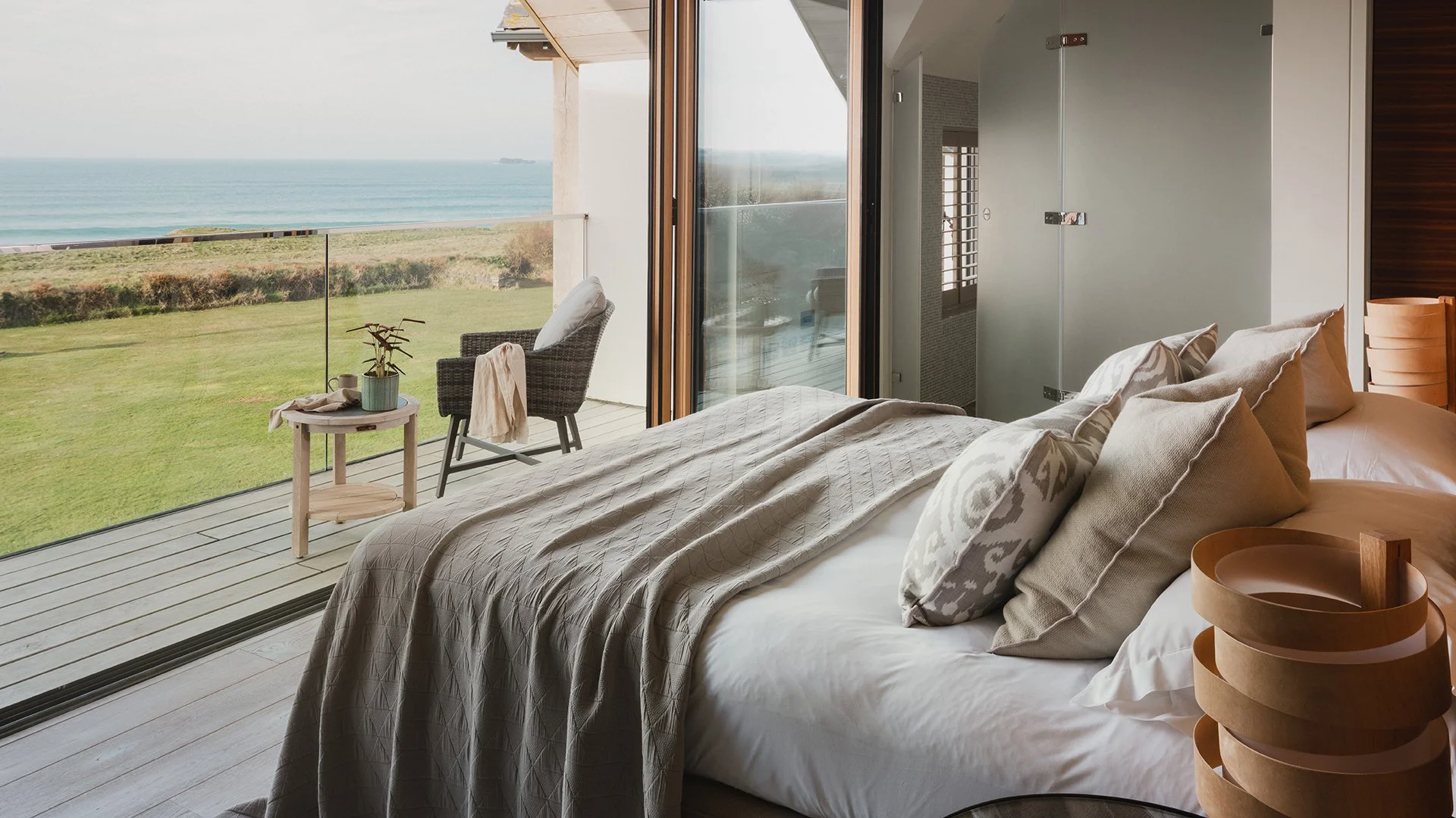 Five beautiful bedrooms have stunning sea views as well as a sumptuous ViSpring bed; two feature oak four-posters. The deck-chair colour scheme, beautiful bleached wood and tree trunk stools add to the coastal chic. 