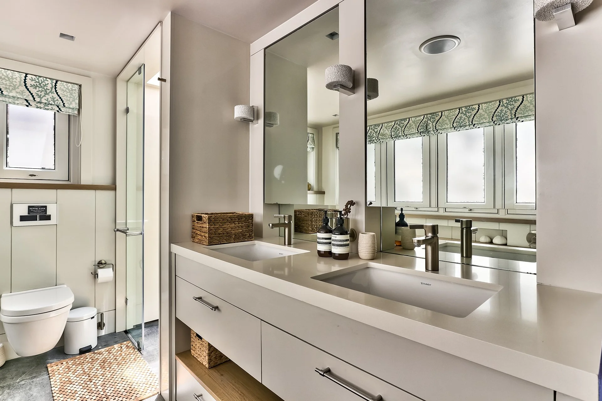 The master bedroom has a spacious bathroom with two sinks, shower and contemporary freestanding oval bath. One guest room has a bathroom with shower and contemporary freestanding oval tub; the other has a shower room.