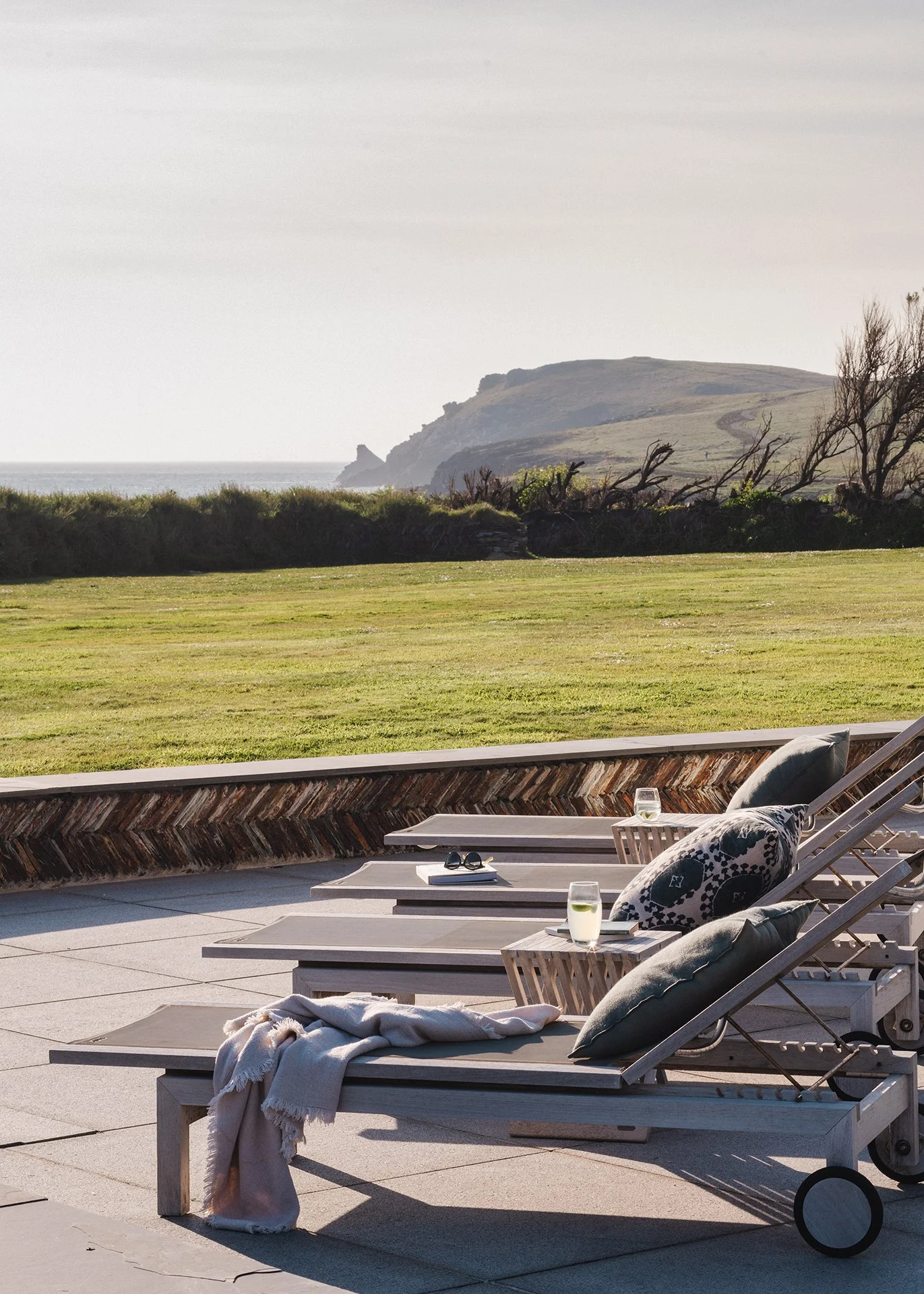 The acre of garden, featuring native plants and grasses, has a terrace with sun loungers, BBQ, Table Tennis table, firepit and extra seating. A gate offers direct access to the South West Coast Path and down to the beach. There’s an outdoor shower to