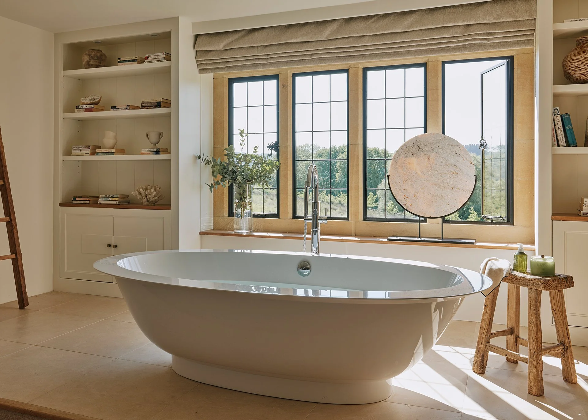 The master bedroom features a free-standing bath with views of the beautiful Cotswolds countryside.