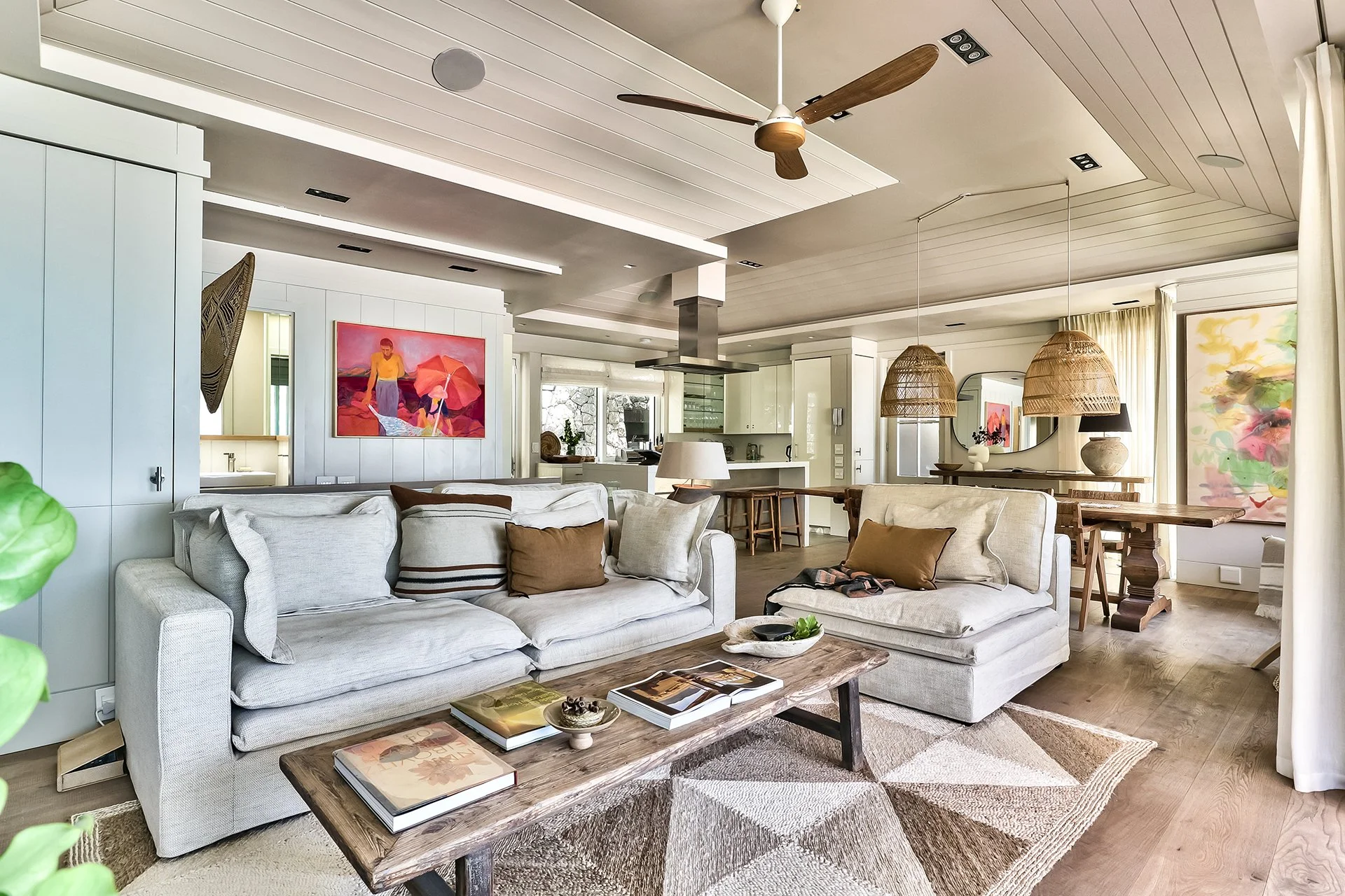 Open-plan space fusing kitchen, dining and living areas with dreamy views and access to beachfront deck through floor-to-ceiling windows. In the living room and dining area there’s a magnificent artisan wood dining table with space for eight guests, 