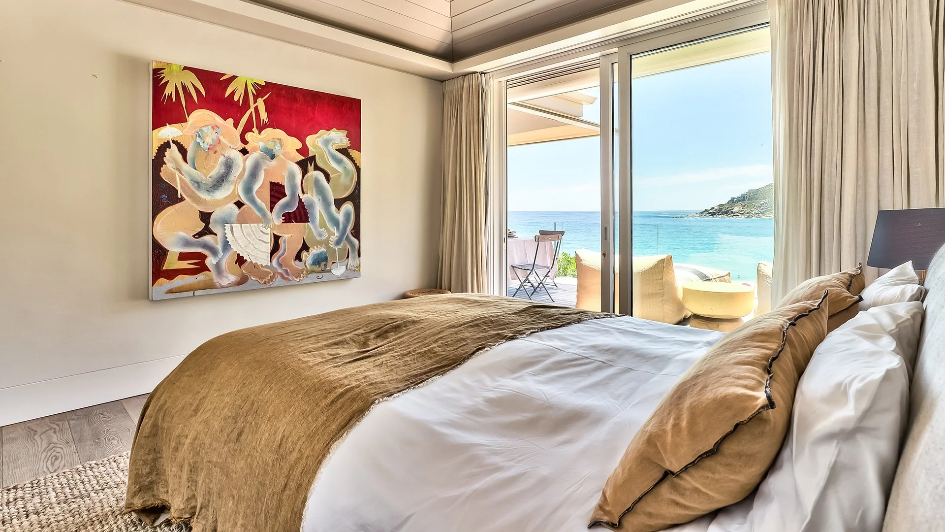 Each of the three bedrooms has an en suite bathroom, king-size bed and access to outside decked areas through floor-to-ceiling windows. The master bedroom has a spacious bathroom with two sinks, shower and contemporary freestanding oval bath.