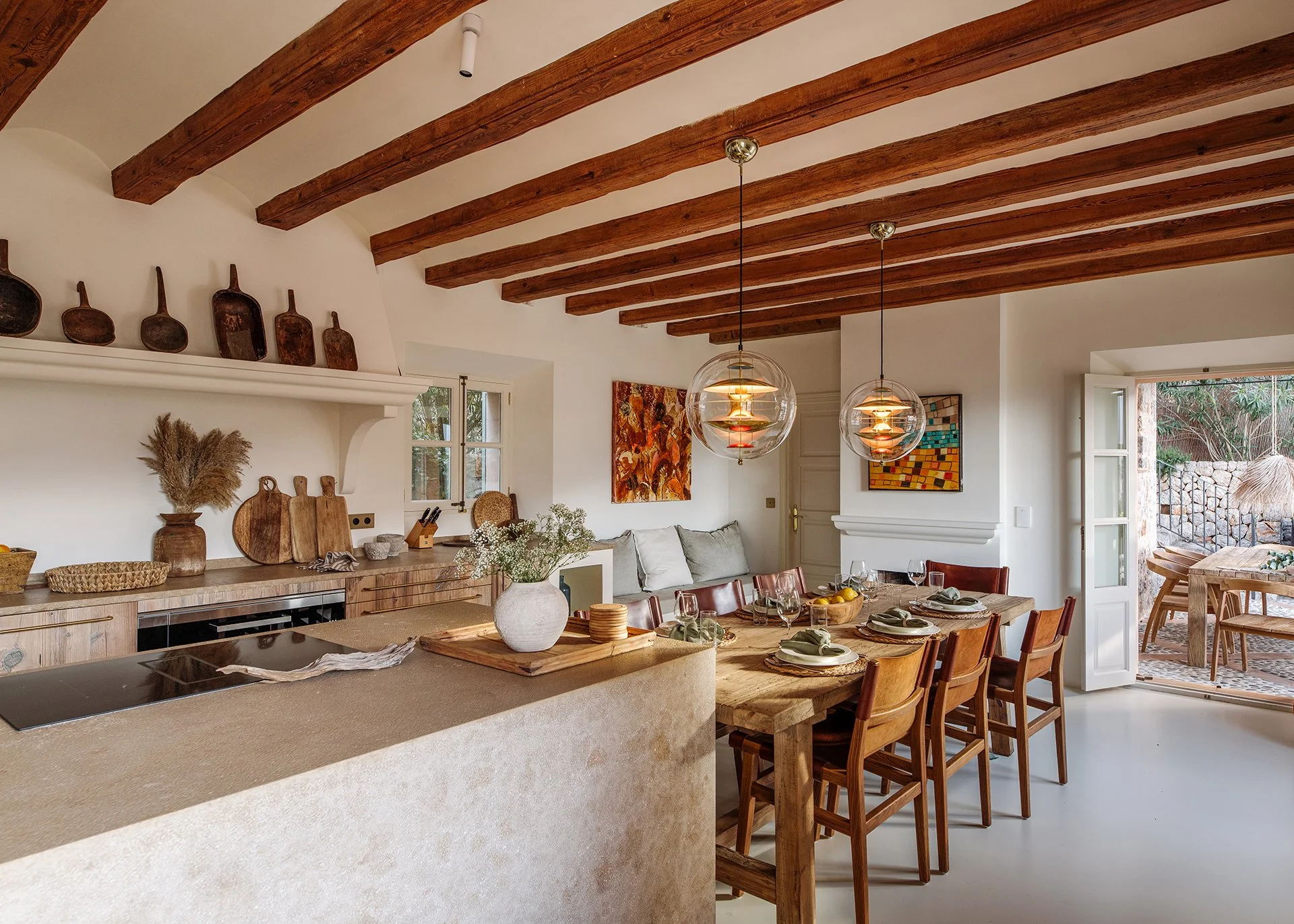 Magnificent Kevin Reilly ‘Altar’ chandelier suspended over the Andrianna Shamaris teak butterfly kitchen table for inside dining.