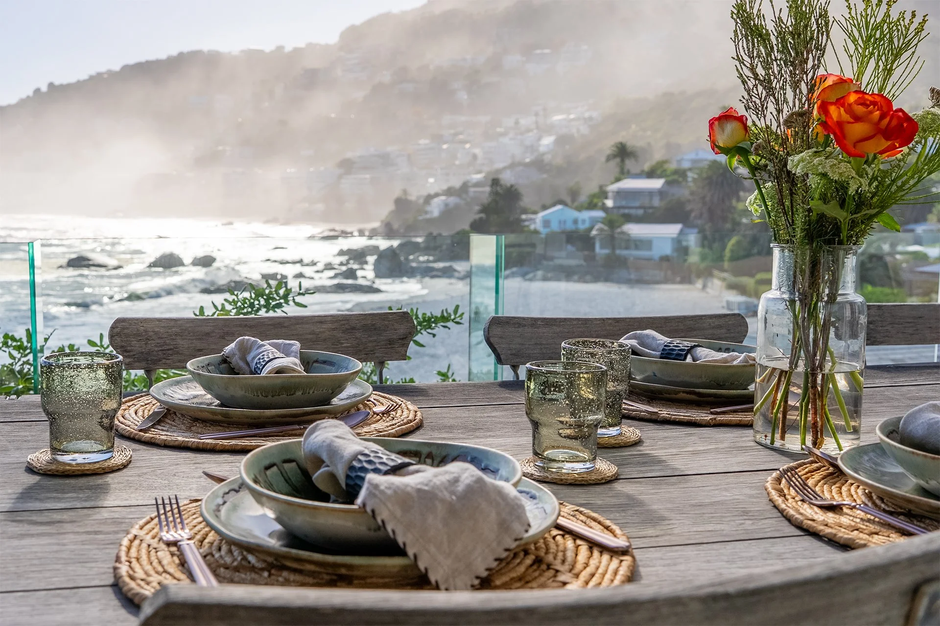 The open-plan kitchen, dining, living area and floor-to-ceiling windows open onto a spectacular glass-walled deck with gorgeous views. 