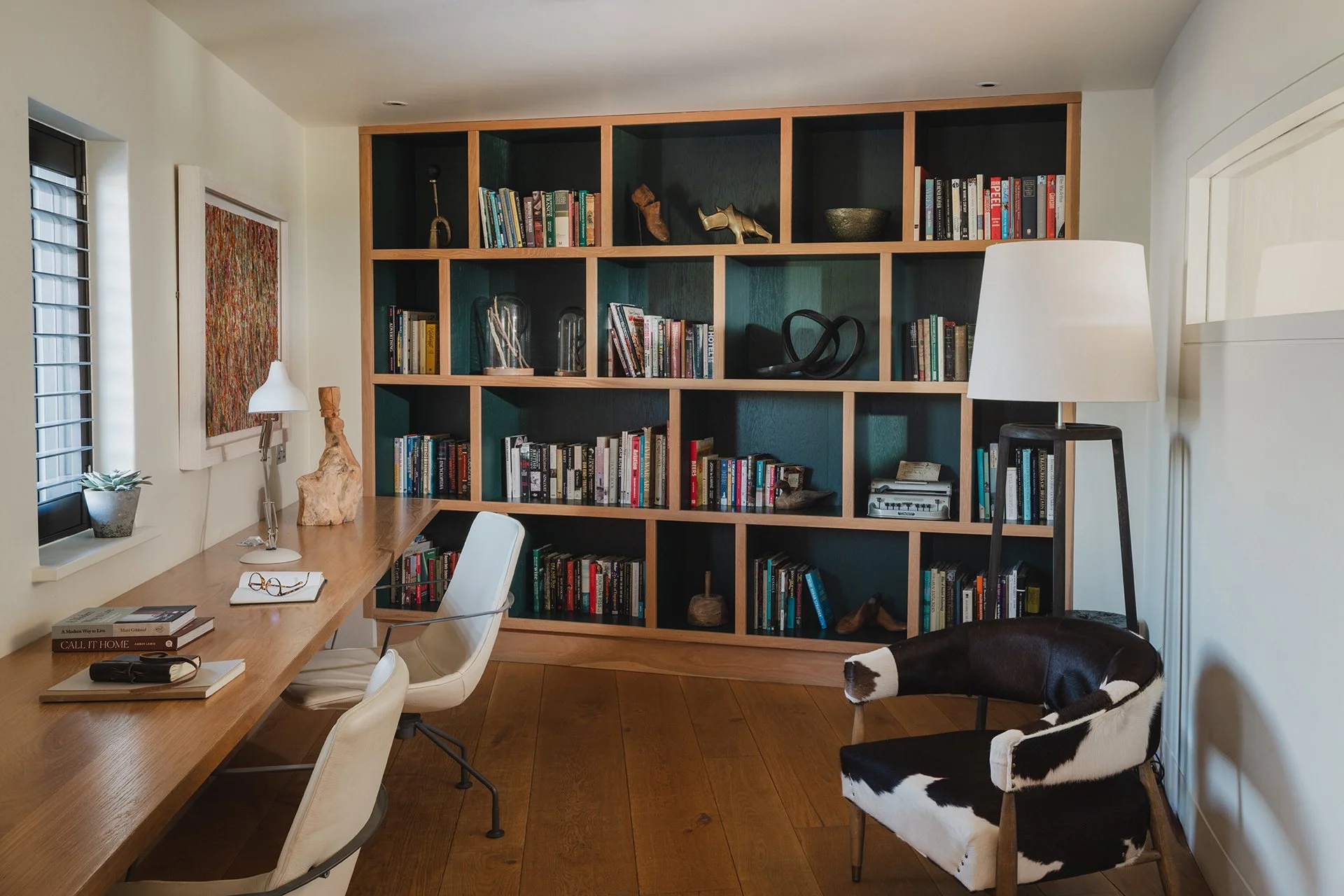 A stylish study with plenty of books provides an extra space.