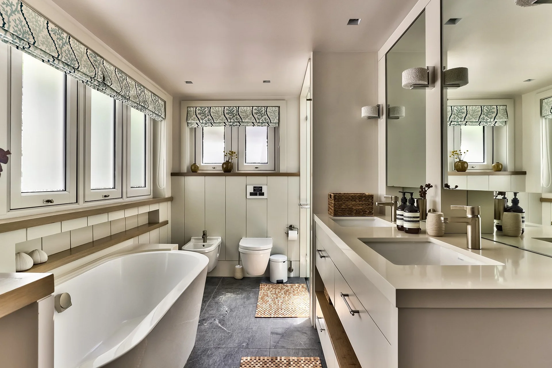 The master bedroom has a spacious bathroom with two sinks, shower and contemporary freestanding oval bath.