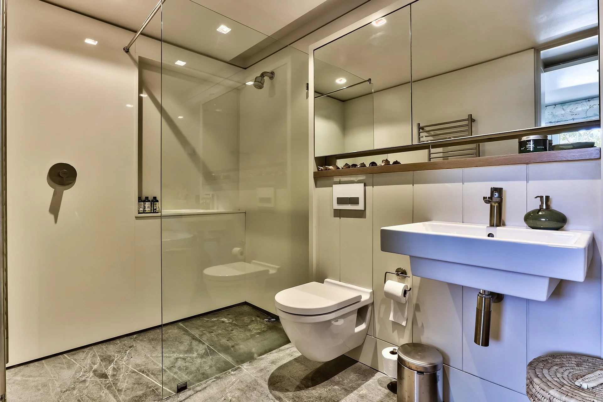 One guest room has a bathroom with shower and contemporary freestanding oval tub; the other has a shower room.