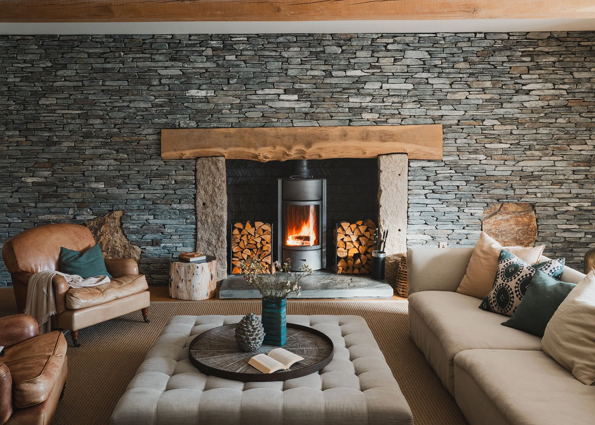 The living room’s homely feel is boosted by its Stuv woodburner, inviting sofas and luxury linens, leather and wood. A large round games table is perfect for late-night Scrabble and Monopoly marathons.