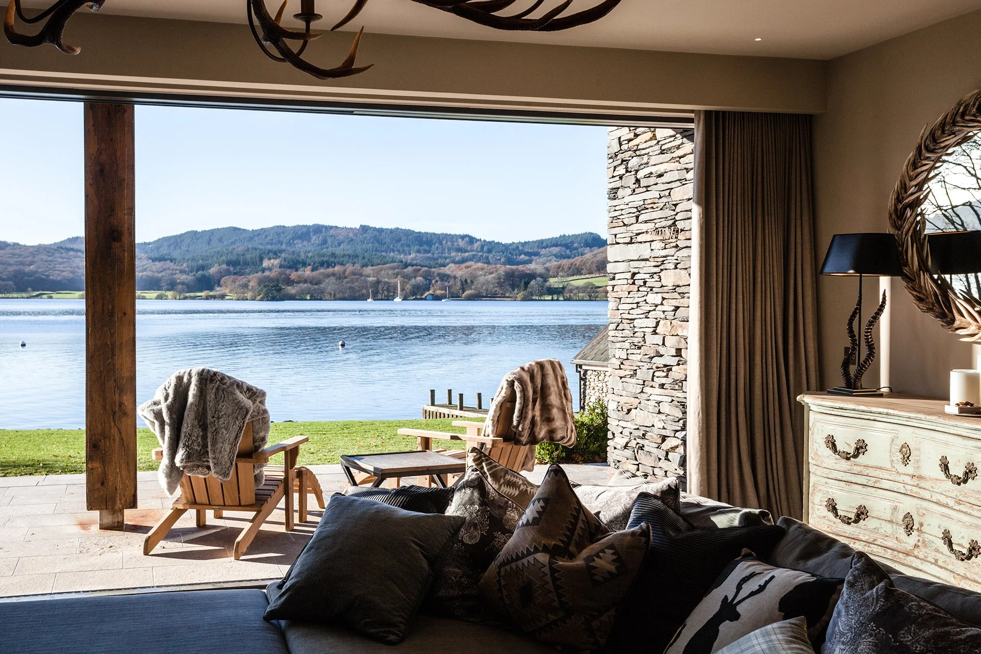 The lake house sleeps up to 10 guests in five bedrooms with interiors features such as decorative antlers, warm plaid fabrics and faux fur rugs contributing to its ski chalet/hunting lodge vibe.
