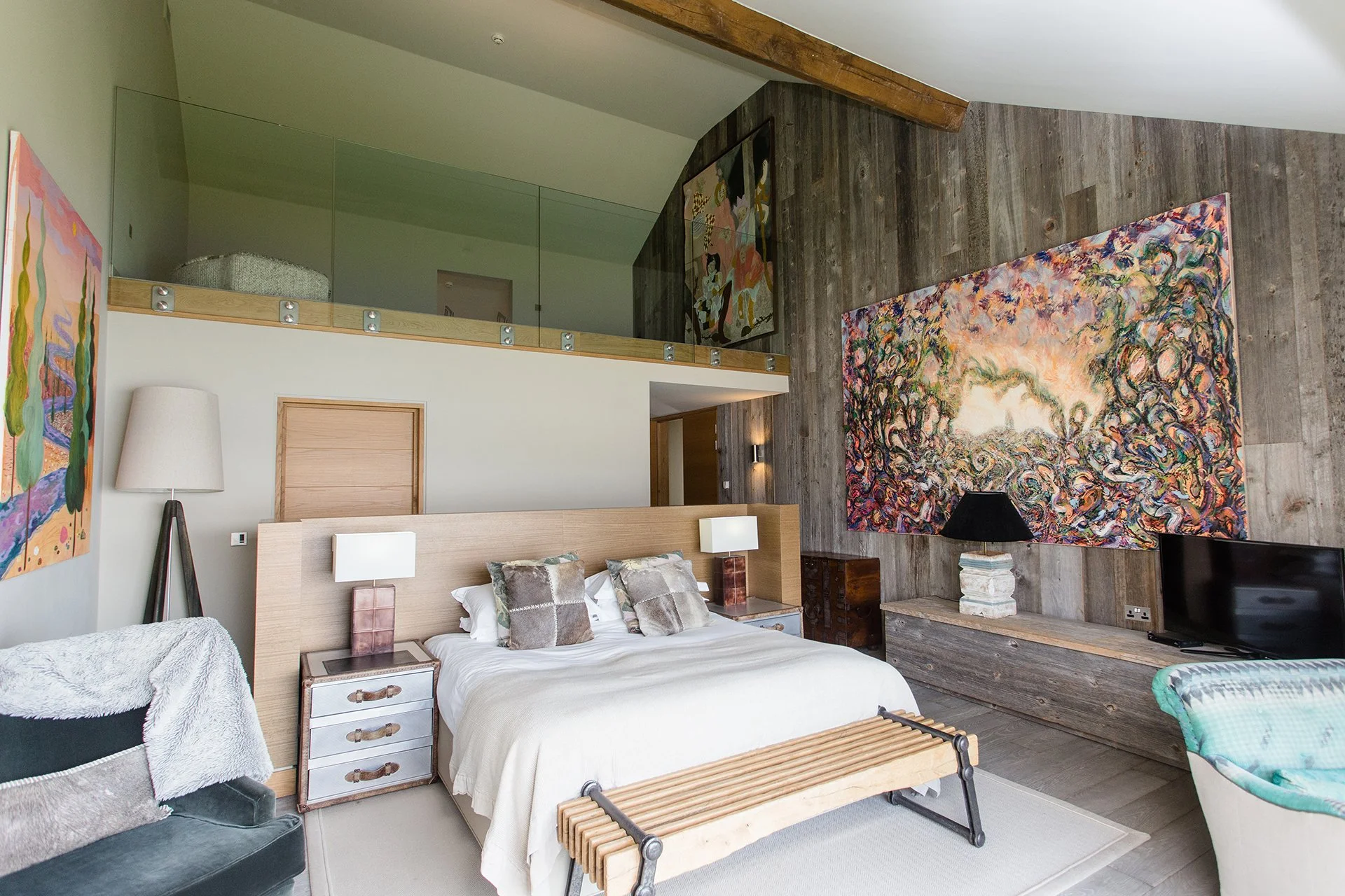 A bespoke glass and stainless steel staircase leads to five en-suite bedrooms with floor-to-ceiling windows, four of which have uninterrupted lake views three have balconies. Each has a ViSpring bed, two of which can be made up as twins.
